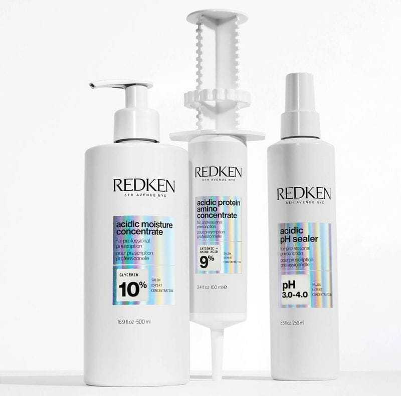 Redken hair care products in white bottles for moisture, protein, and pH balance.