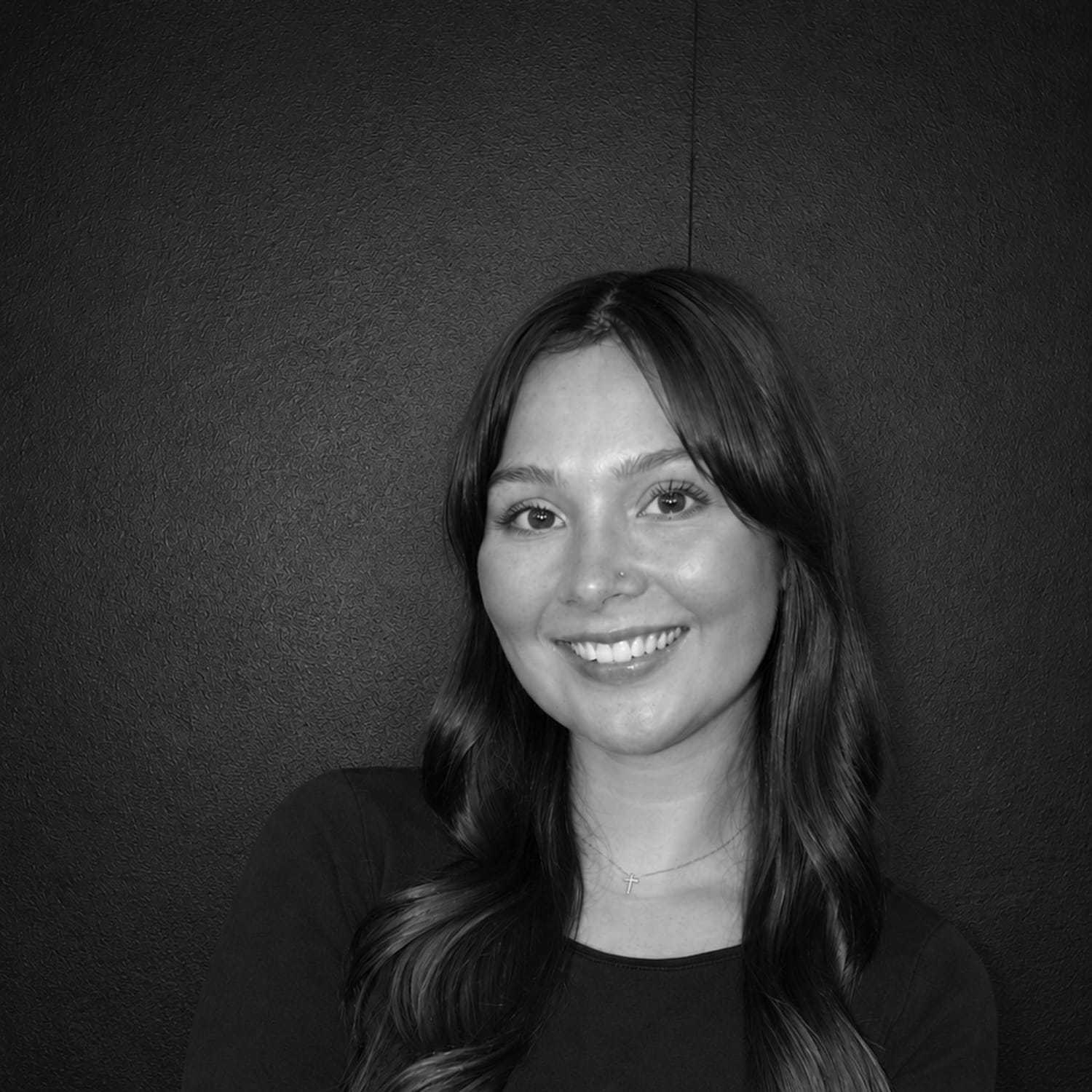 Portrait of Ananda Melleby, a professional stylist at Salon CG, showcasing their expertise and style.